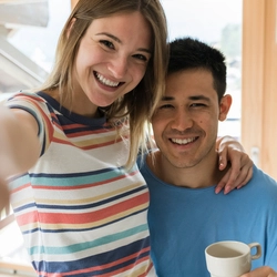 Two happy Own Up customers smile at the camera