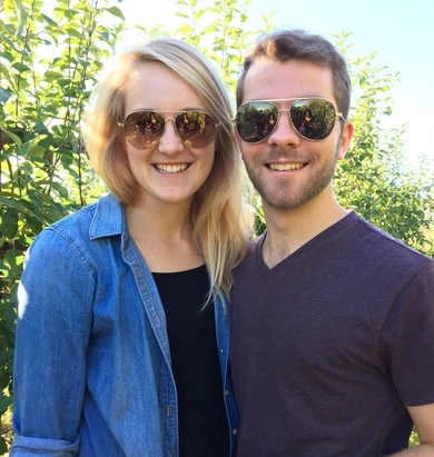 smiling woman with sunglasses and smiling man with sunglasses