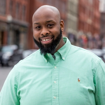 Real estate agent Claudel Frederique smiles at the camera